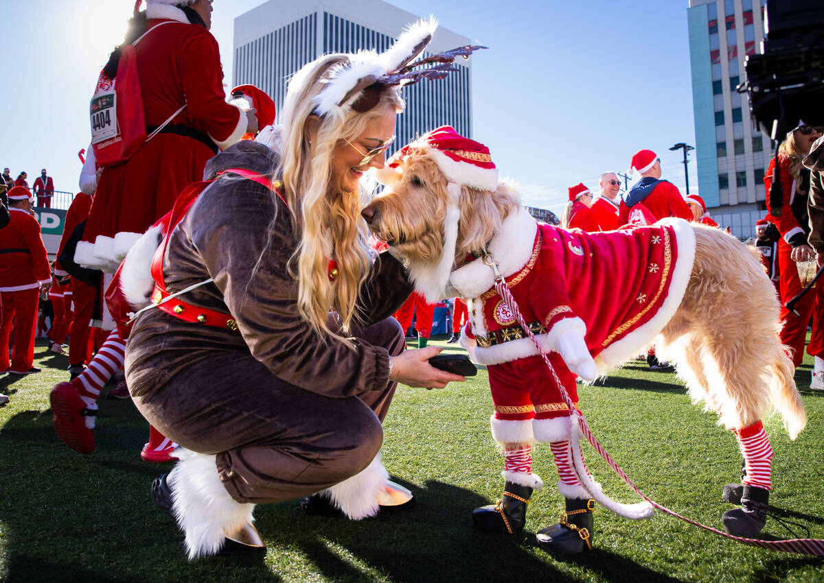 Jenna Waltho, of Las Vegas, talks with her dog, Junior, before the start of the 21st annual Gre ...