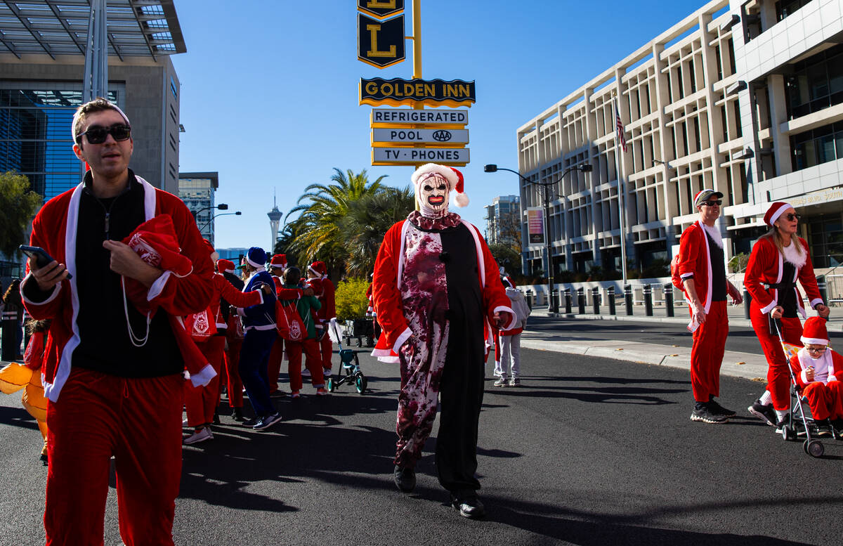 An attendee dressed as Art the Clown from "Terrifier" approaches the finish line duri ...