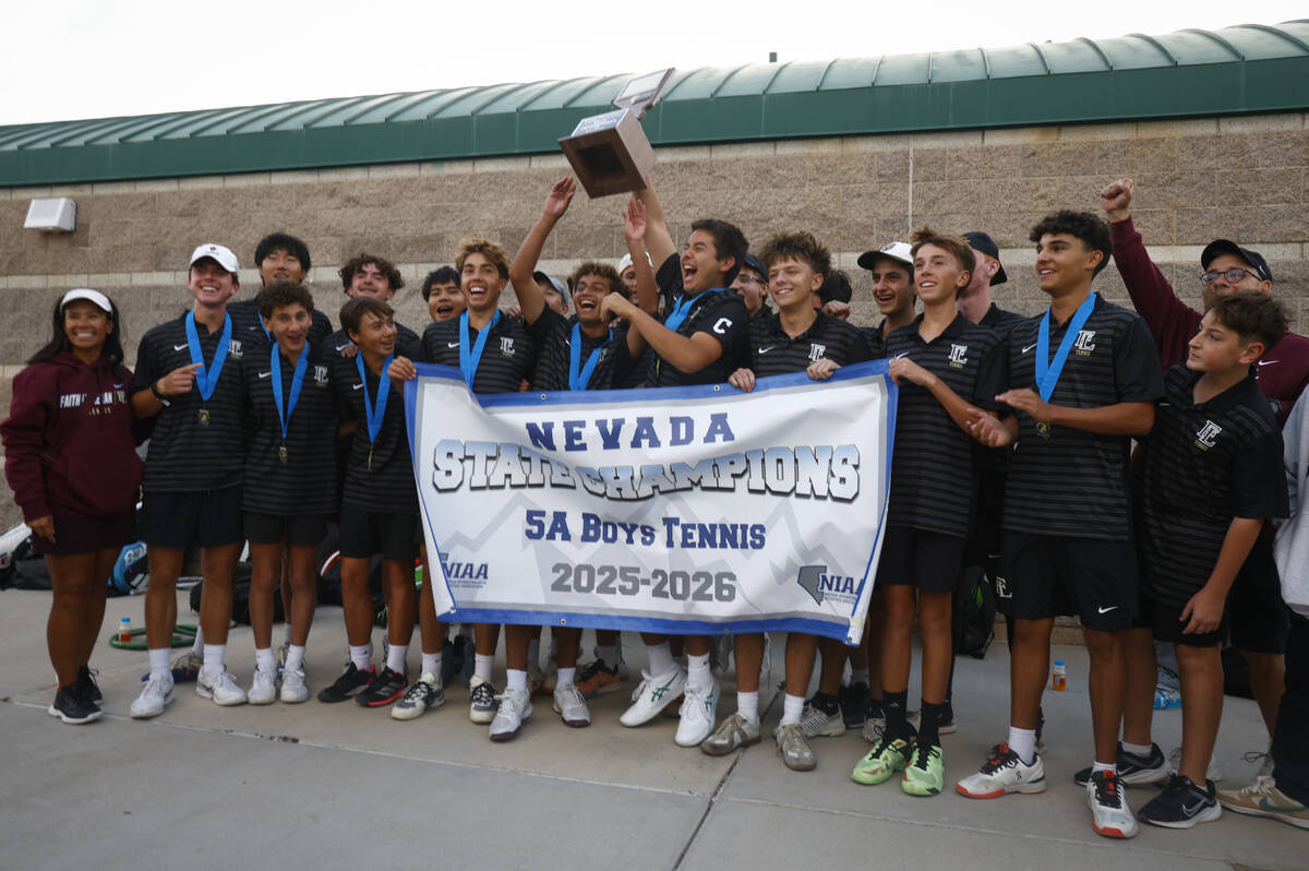 Faith Lutheran players and coaches pose with the trophy after defeating Palo Verde to win the 5 ...