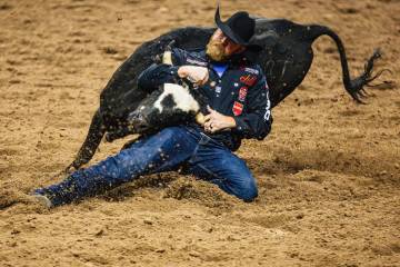 Will Lummus wrestles a steer on day four of the National Finals Rodeo at the Thomas & Mack ...