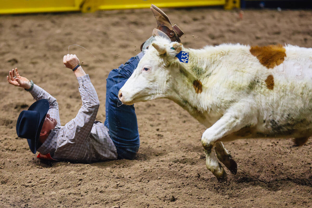 Chance Howard falls over during steer wrestling on day four of the National Finals Rodeo at the ...