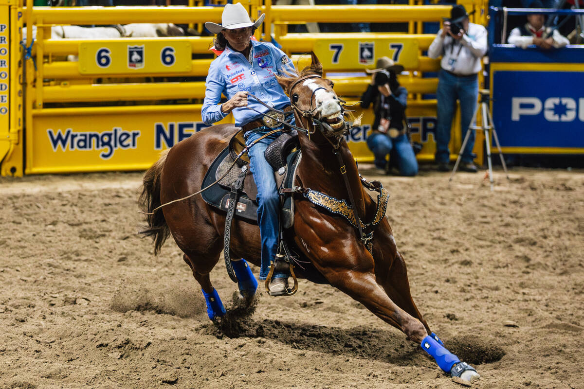 Lisa Lockhart races into the arena on day four of the National Finals Rodeo at the Thomas & ...