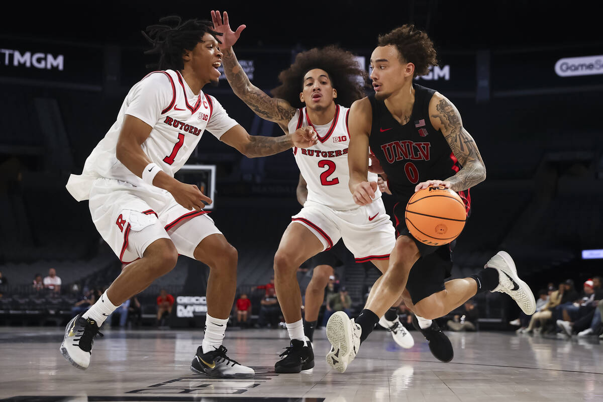 UNLV guard Dravyn Gibbs-Lawhorn (0) drives to the basket as Rutgers guards Jamichael Davis (1) ...