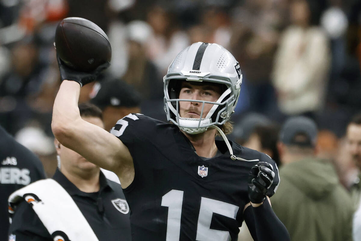 Raiders quarterback Kenny Pickett (15) throws a pass during a warm up before an NFL football ga ...