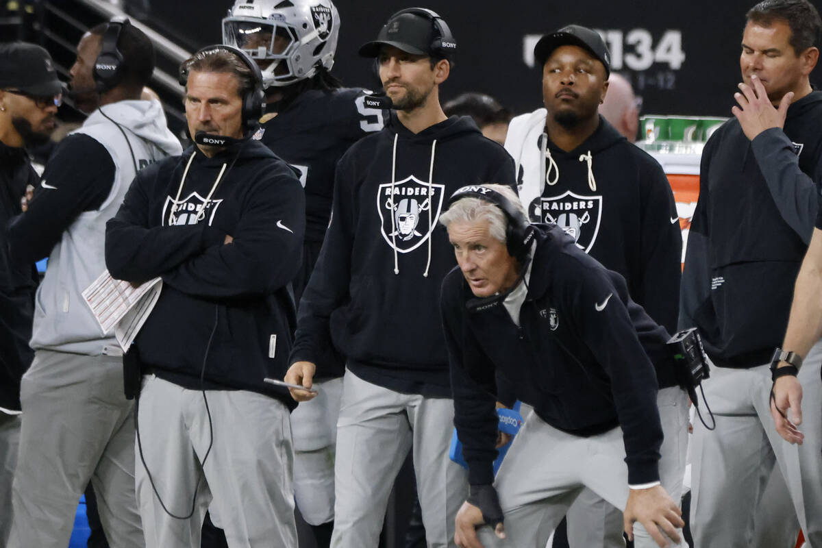 Raiders interim offensive coordinator Greg Olson, left, and head coach Pete Carroll watch from ...