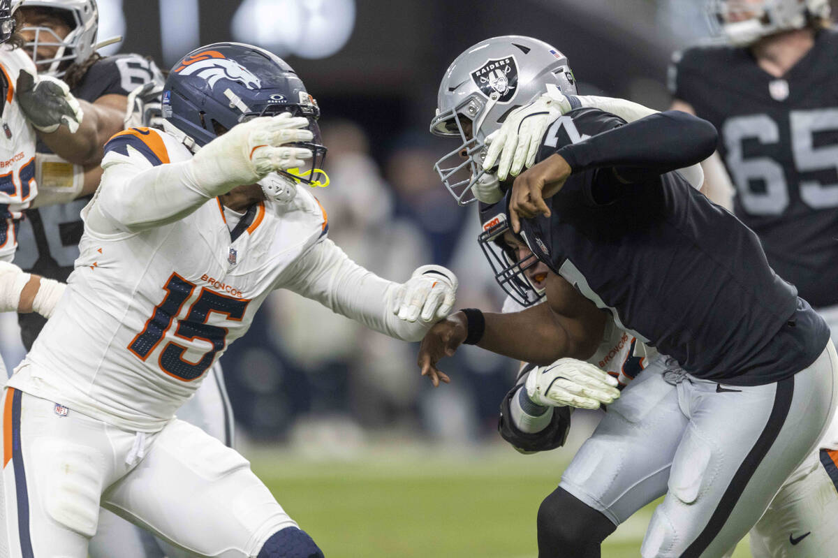 Denver Broncos linebacker Nik Bonitto (15) pursues Raiders quarterback Geno Smith (7) during th ...