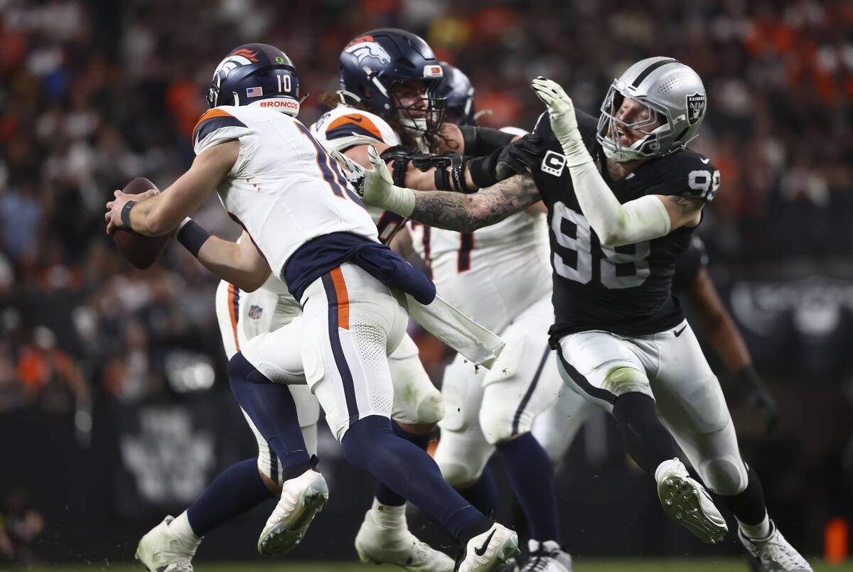 Raiders defensive end Maxx Crosby (98) chases after Denver Broncos quarterback Bo Nix (10) duri ...