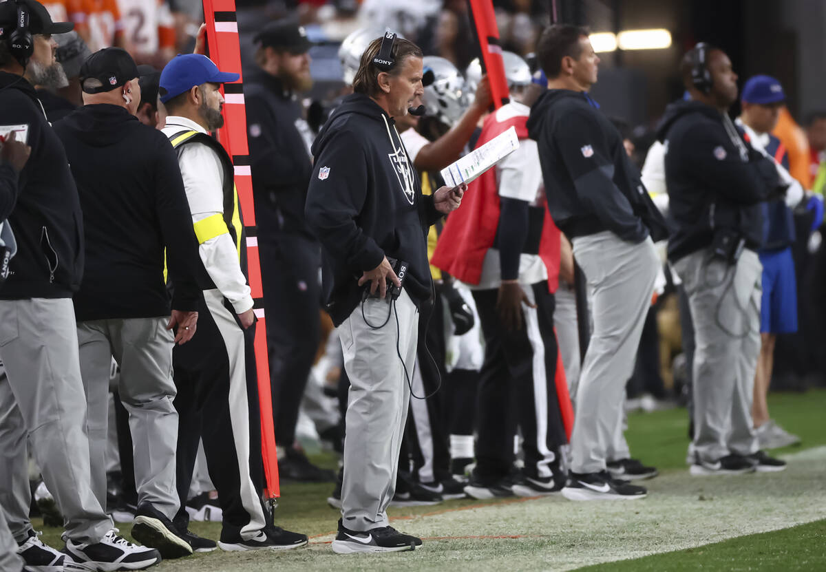 Raiders interim offensive coordinator Greg Olson looks over notes during the second half of an ...