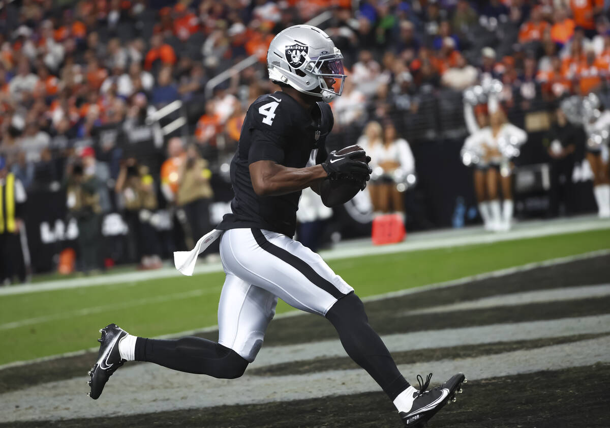 Raiders wide receiver Shedrick Jackson (4) scores a touchdown against the Denver Broncos during ...