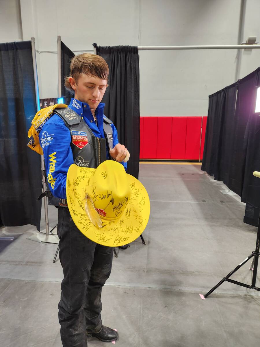 Statler Wright shows off the cowboy hat he wore while winning Saturday night's saddle bronc rid ...