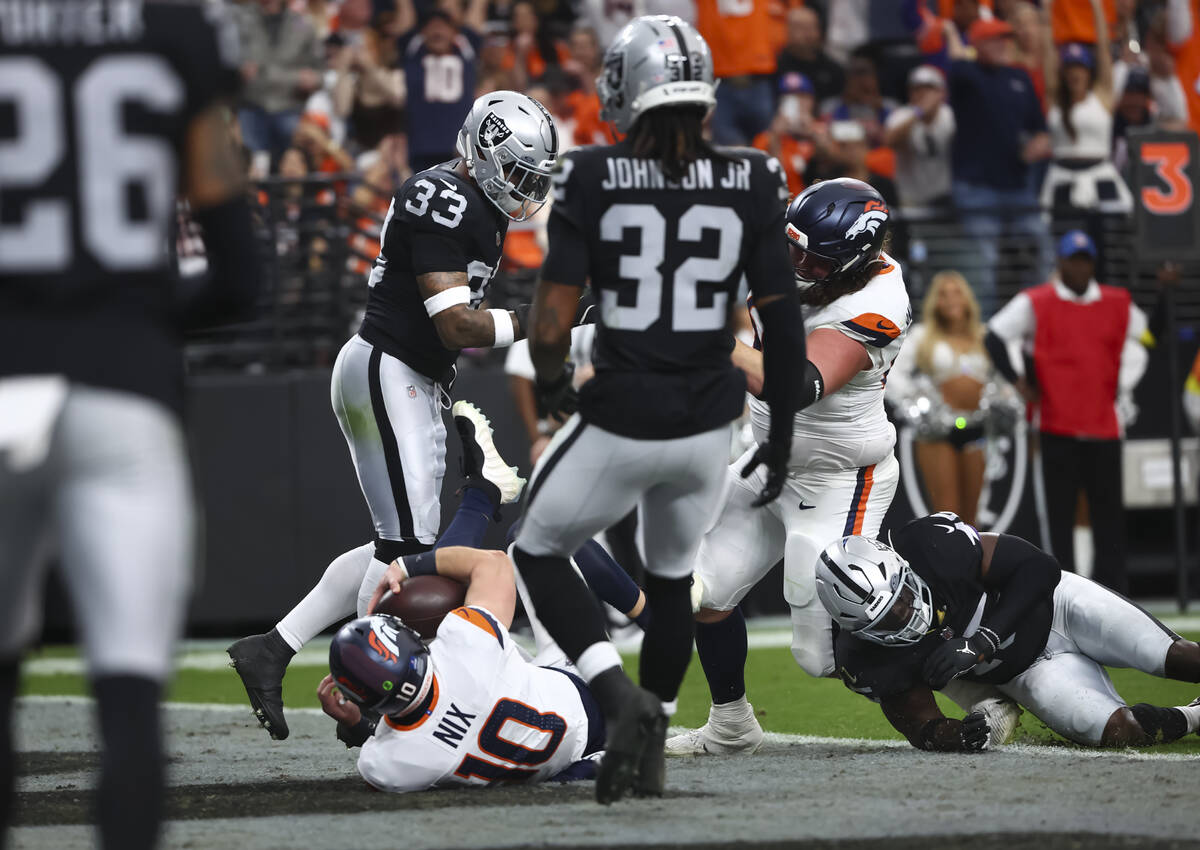Denver Broncos quarterback Bo Nix (10) scores a touchdown against the Raiders during the first ...