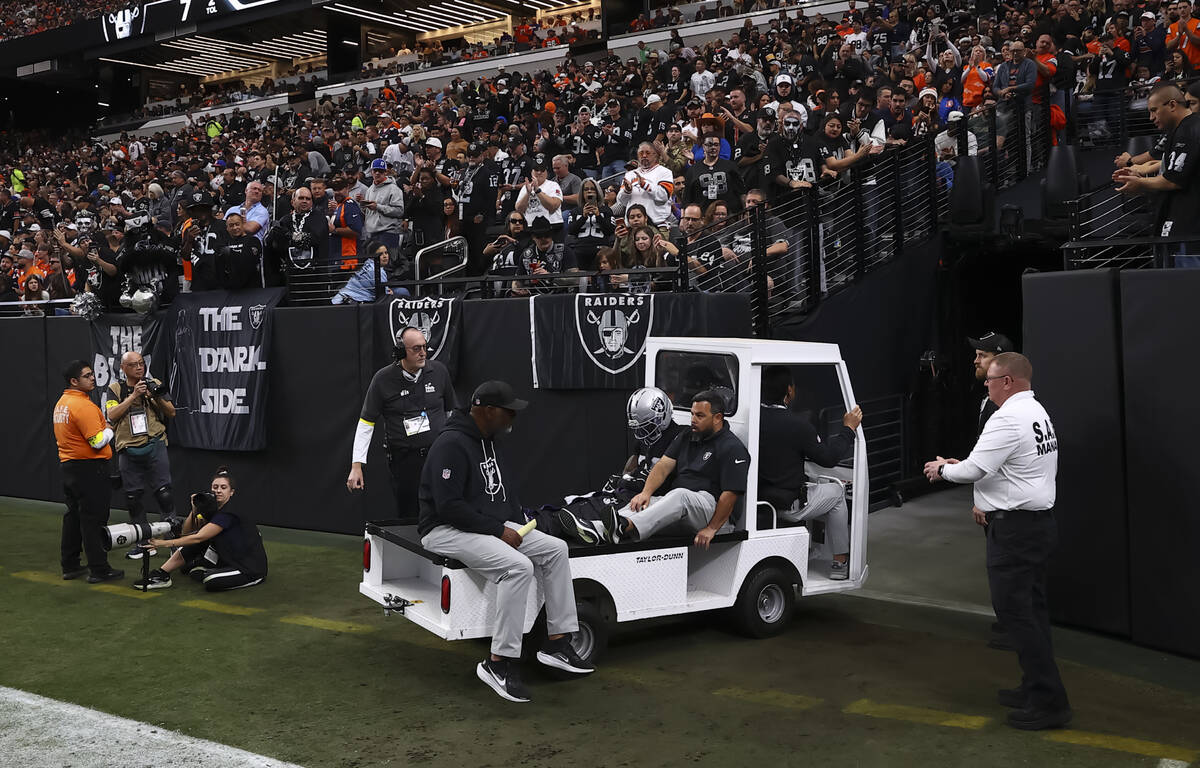Raiders cornerback Kyu Blu Kelly (36) is wheeled off the field after an injury during the first ...