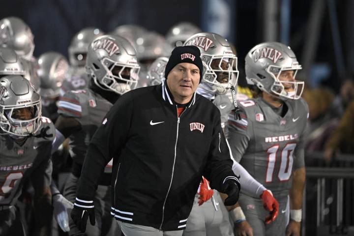 UNLV's head football coach Dan Mullen takes the field against Nevada at Mackay Stadium on ...