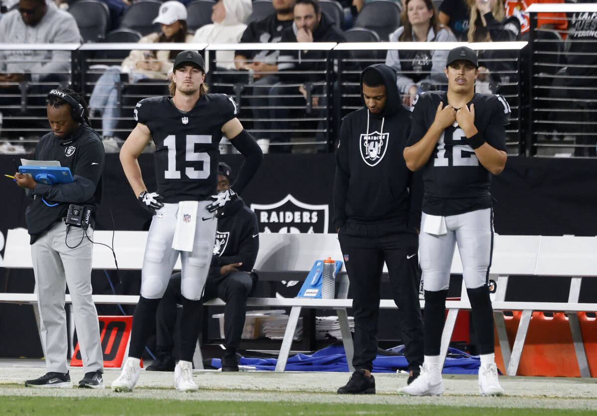 Raiders quarterbacks Kenny Pickett (15) and Aidan O'Connell (12) watch from the sideline d ...