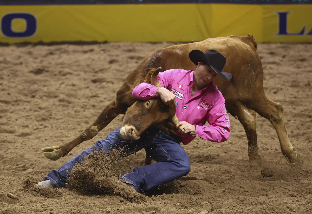 Scott Guenthner competes in steer wrestling during the fifth go-round of the National Finals Ro ...