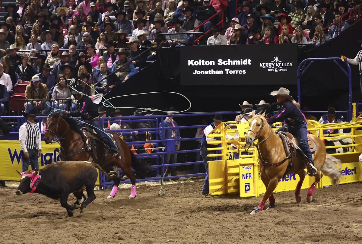Kolton Schmidt and Jonathan Torres compete in team roping during the fifth go-round of the Nati ...