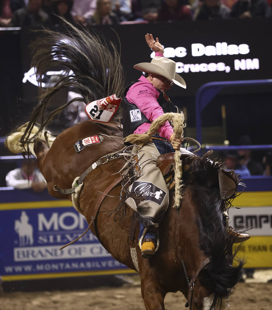 Zac Dallas rides Cat Walk while competing in saddle bronc riding during the fifth go-round of t ...