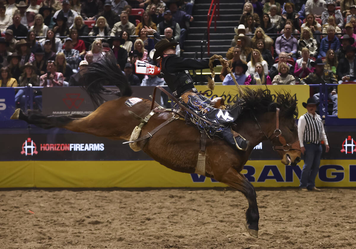 Zeke Thurston rides The Black Tie while competing in saddle bronc riding during the fifth go-ro ...