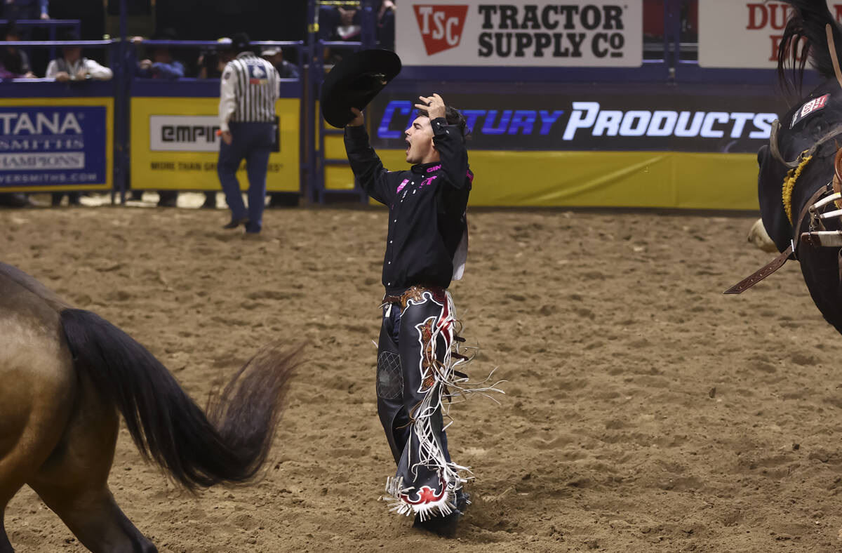 Damian Brennan reacts after placing first in saddle bronc riding during the fifth go-round of t ...