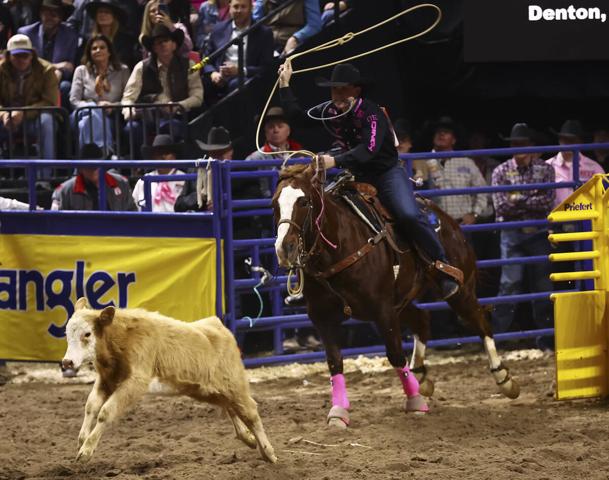 Riley Webb competes in tie-down roping during the fifth go-round of the National Finals Rodeo a ...