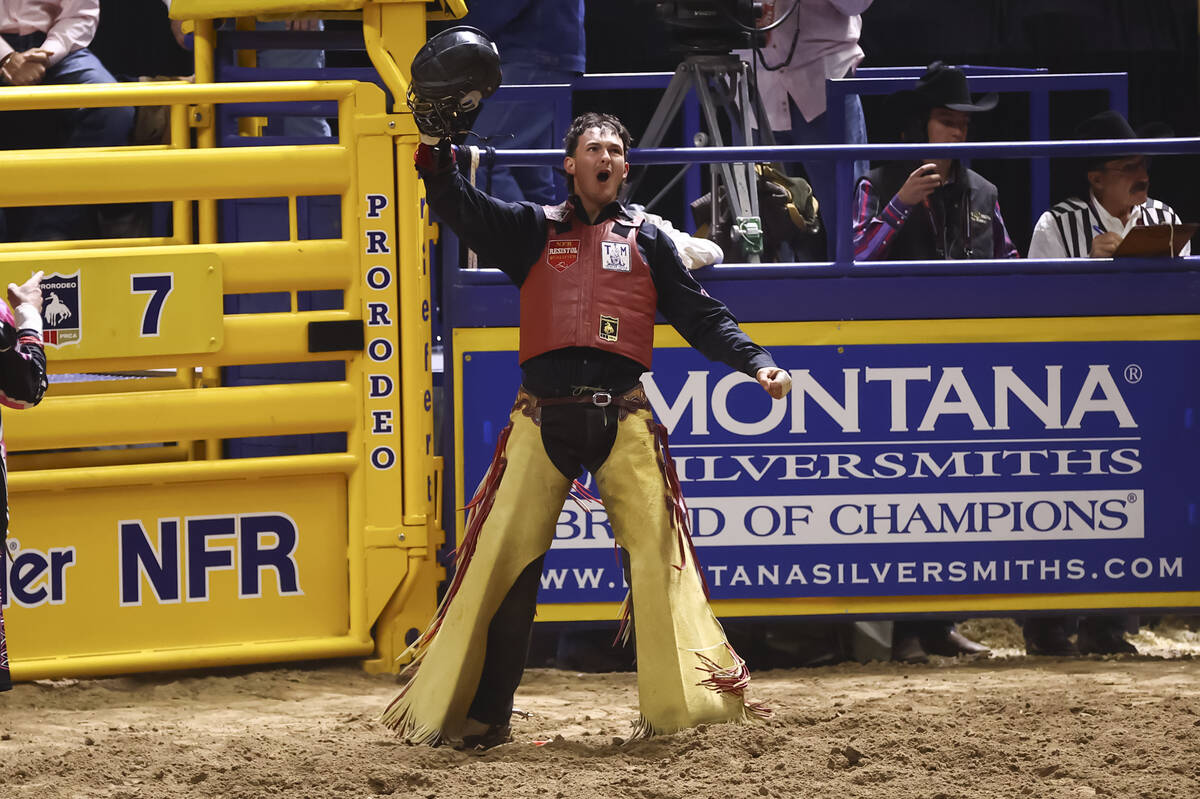 Bryce Jensen reacts after competing in bull riding during the fifth go-round of the National Fi ...