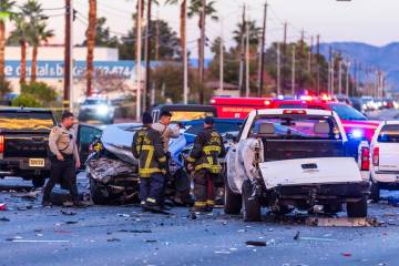 Metropolitan Police officers work with North Las Vegas firefighters as numerous vehicles are in ...