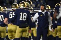 Notre Dame head coach Marcus Freeman, right, celebrates with kicker Erik Schmidt (18) on the si ...