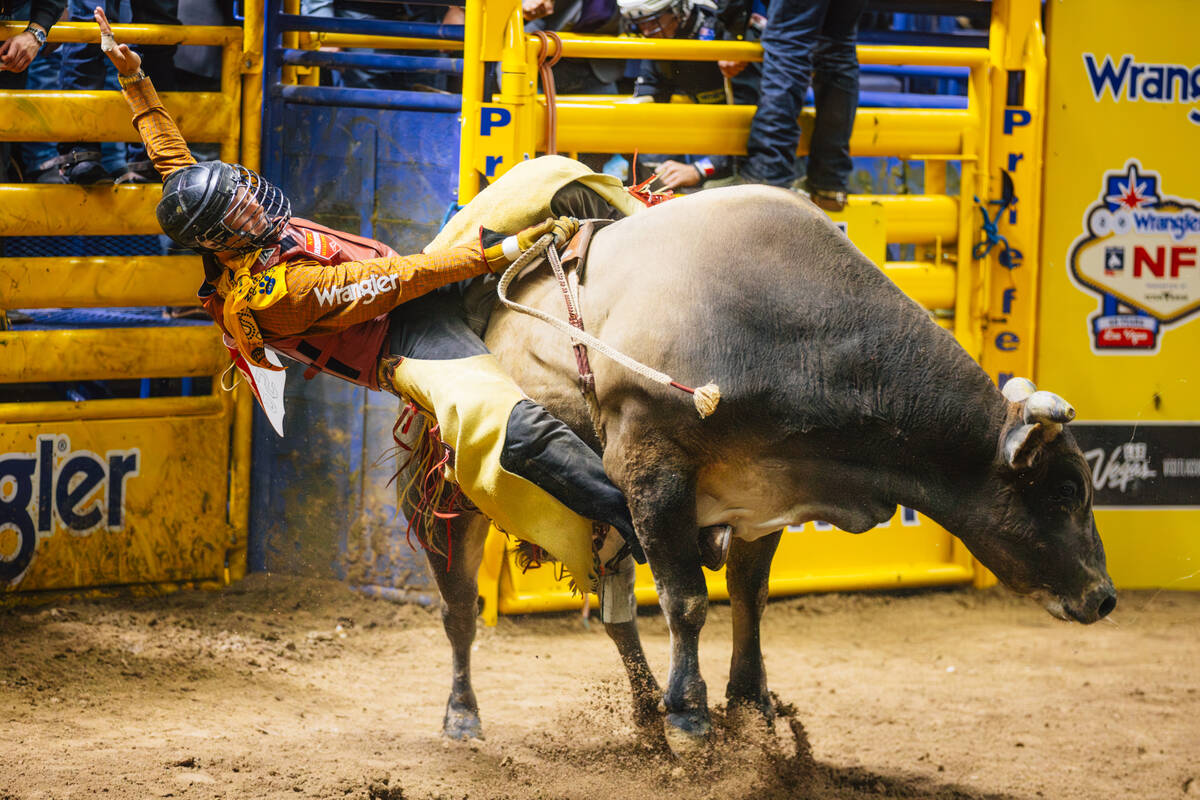 Bryce Jensen falls off of Bad Habits during day three of the National Finals Rodeo at the Thoma ...