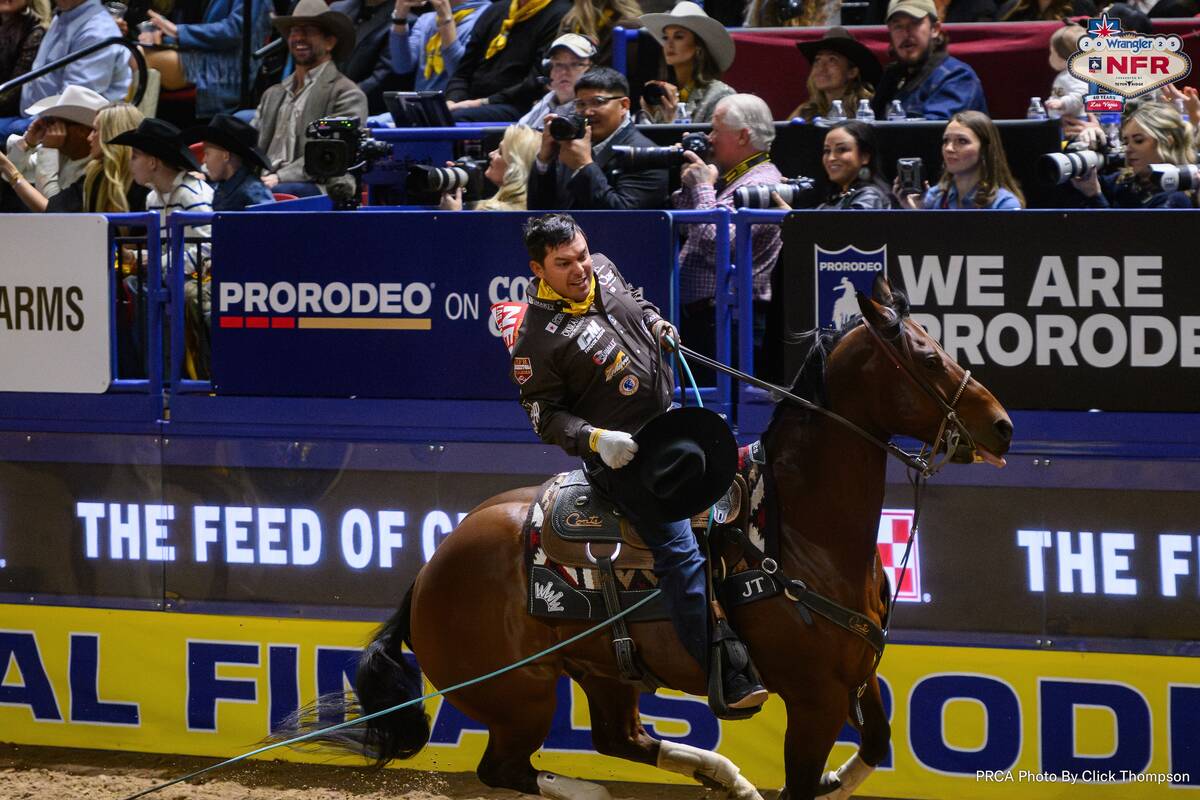 Team roping heeler Jonathan Torres doffs his cowboy hat after he and header Kolton Schmidt loop ...