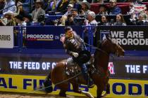 Team roping heeler Jonathan Torres doffs his cowboy hat after he and header Kolton Schmidt loop ...