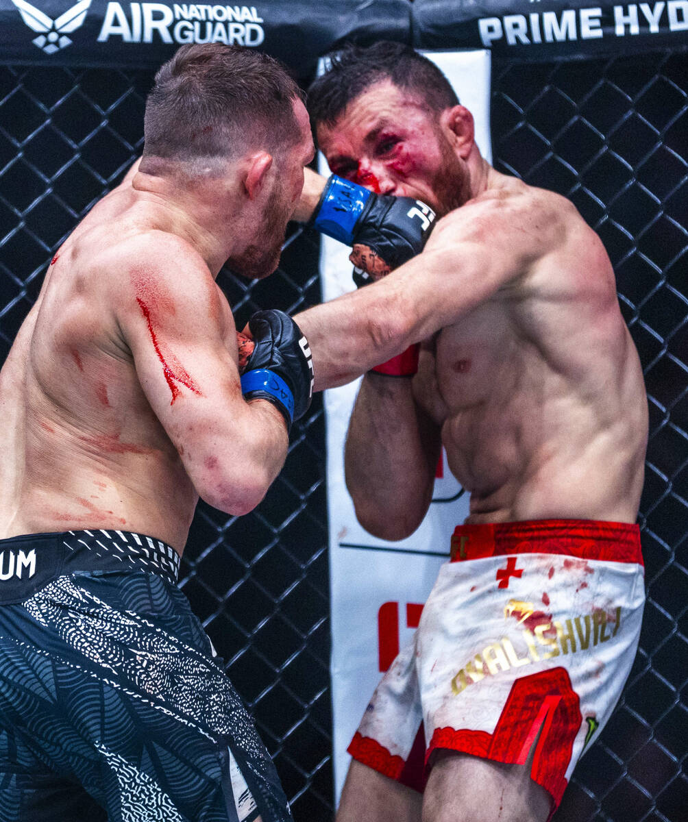 Petr Yan connects with a punch to the face of Merab Dvalishvili during their bantamweight title ...