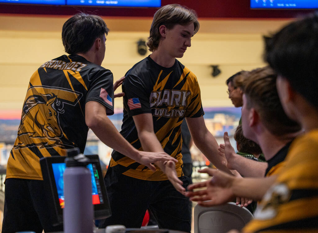 Clark’s Ryland Gregorich is congratulated by his teammates after playing his turn during ...