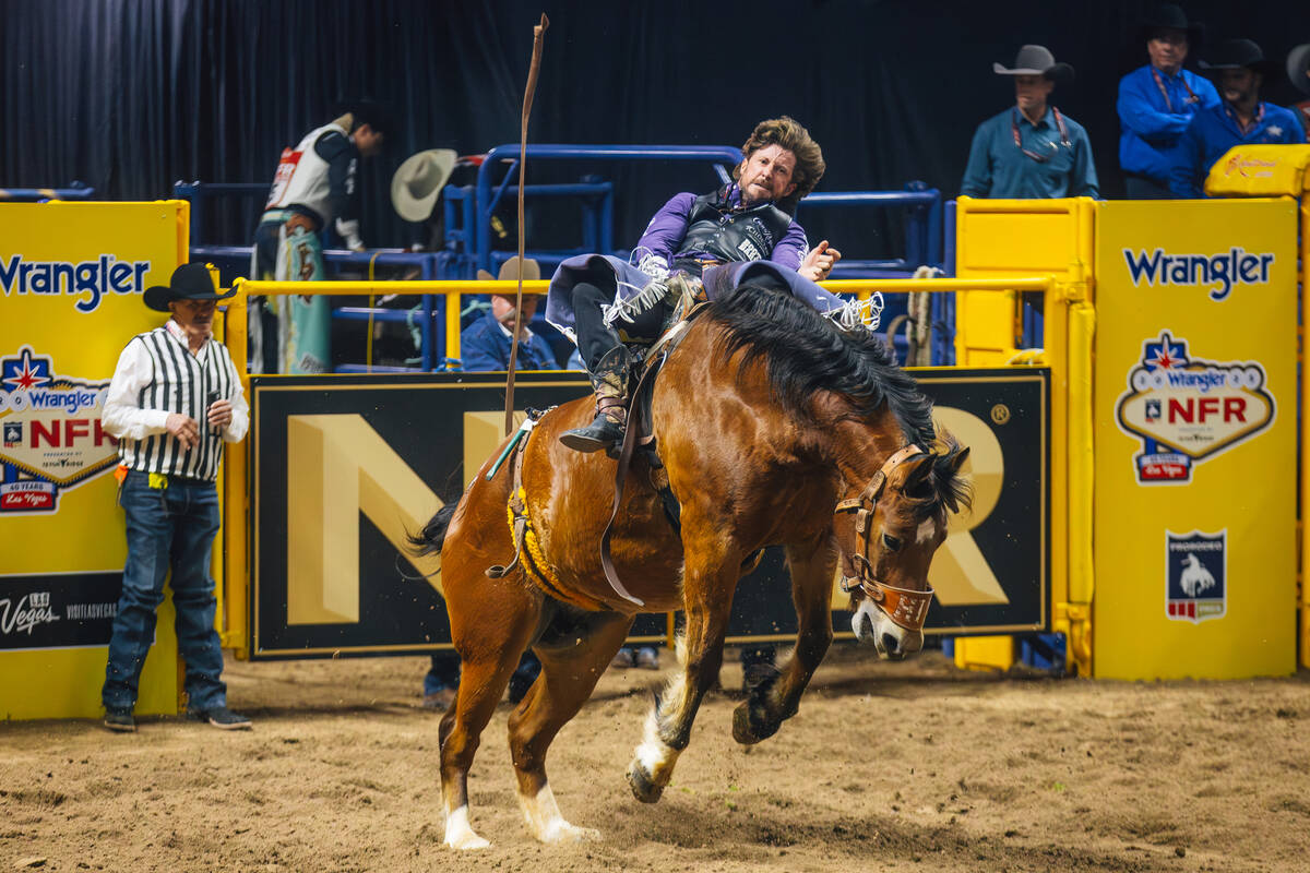 Tilden Hooper rides Square Bale on day four of the National Finals Rodeo at the Thomas & Ma ...