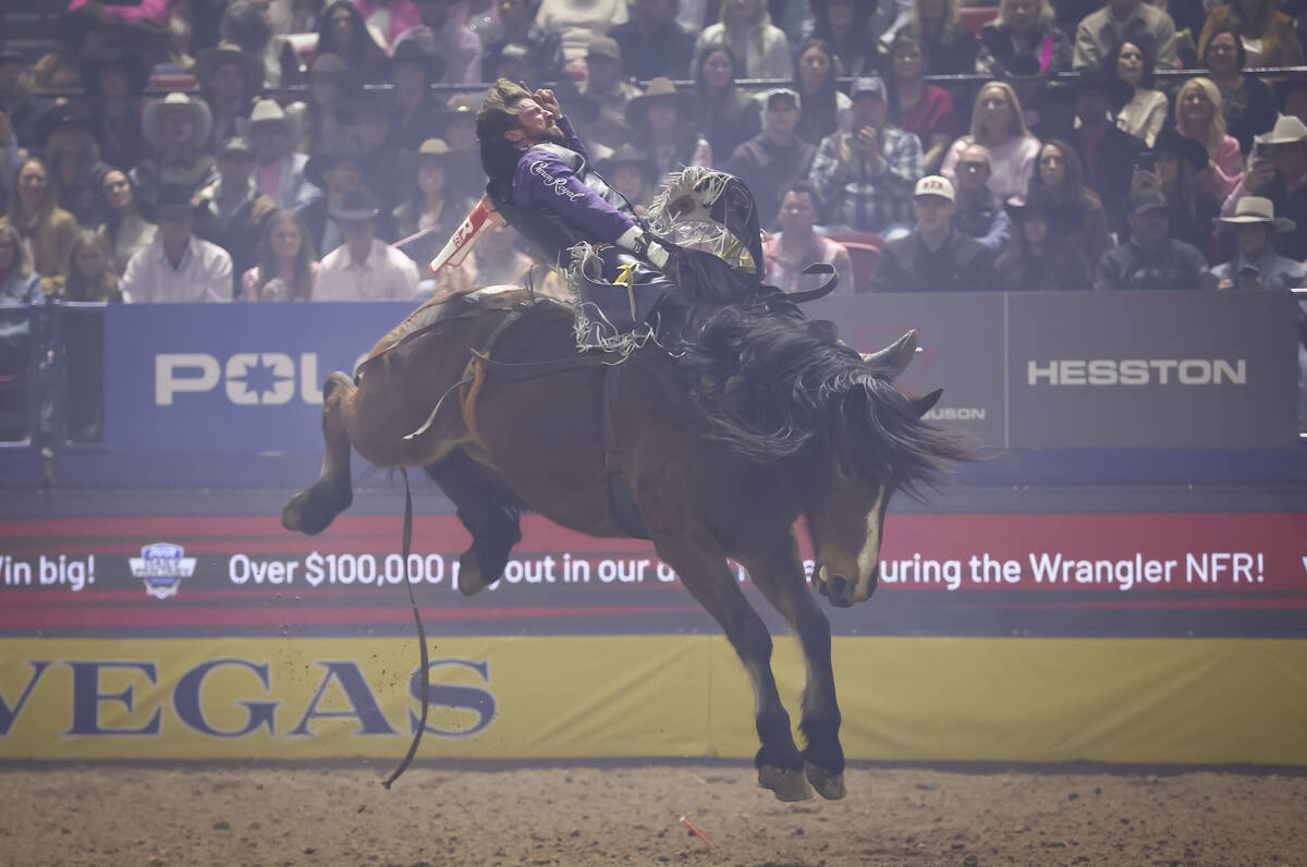 Tilden Hooper rides Straight Stick while competing in bareback riding during the fifth go-round ...