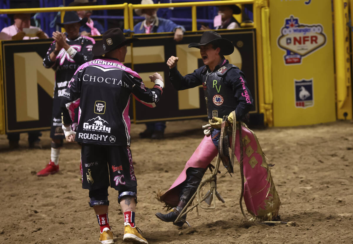 JR Stratford celebrates with bullfighter Dusty Tuckness after competing in bull riding during t ...