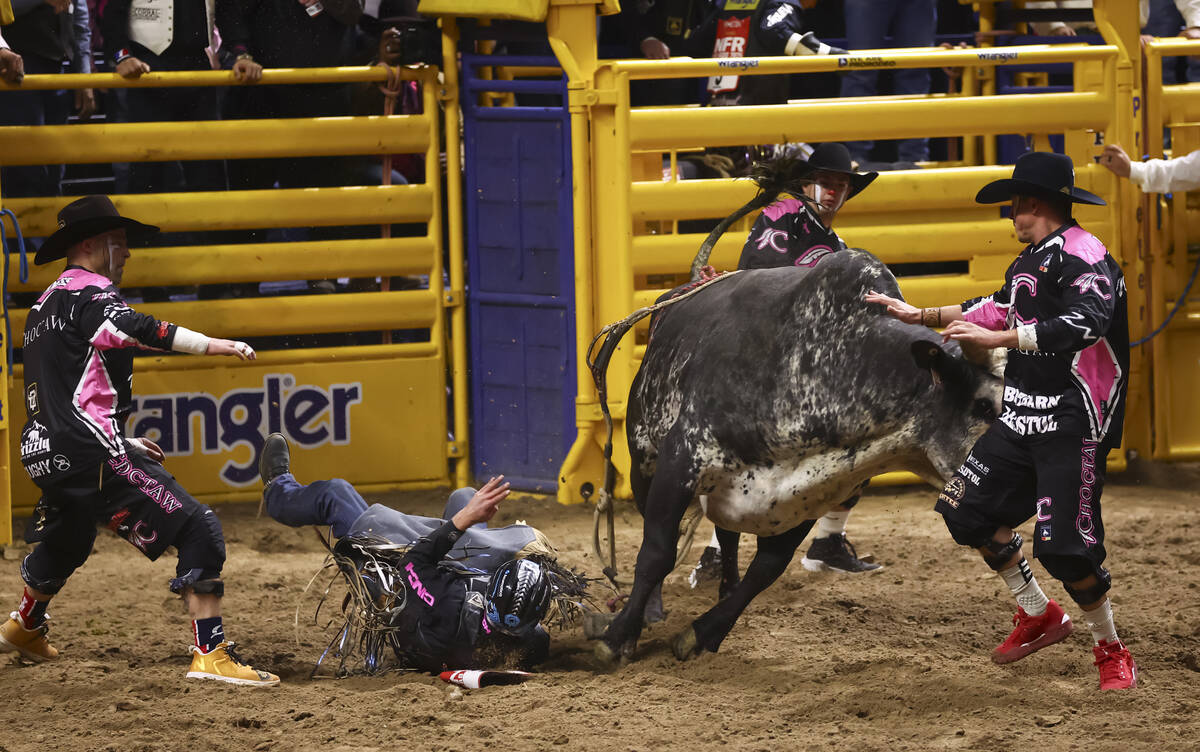 Bullfighters Dusty Tuckness, left, and Cody Webster, right, distract Tesla after TJ Gray, secon ...