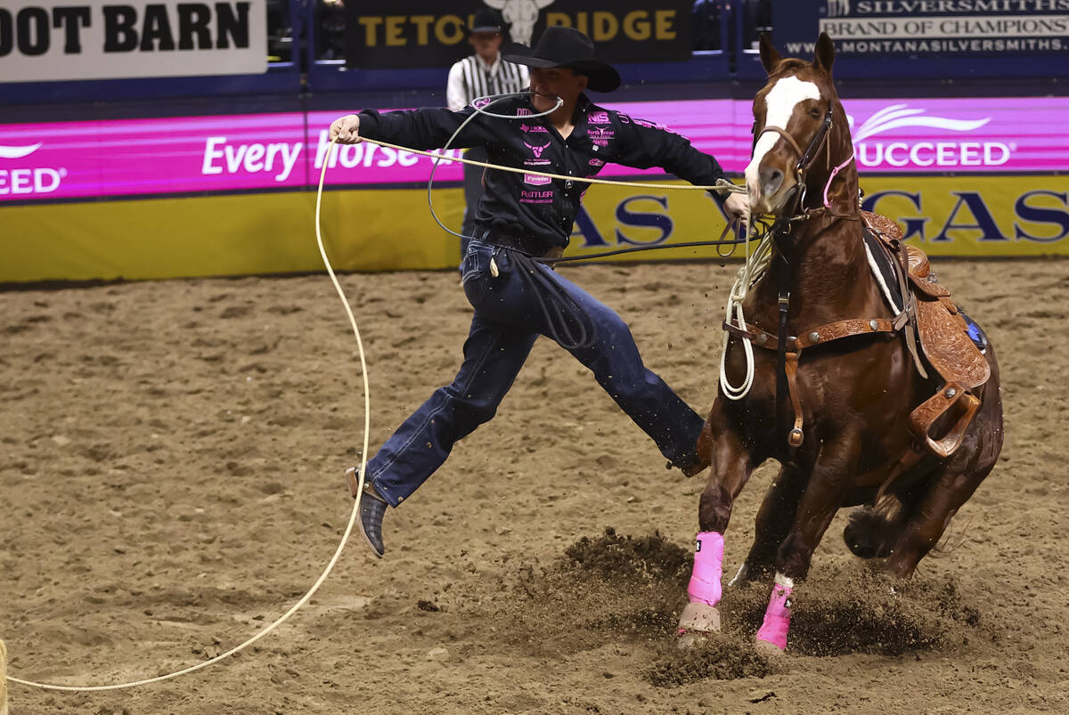 Riley Webb competes in tie-down roping during the fifth go-round of the National Finals Rodeo a ...