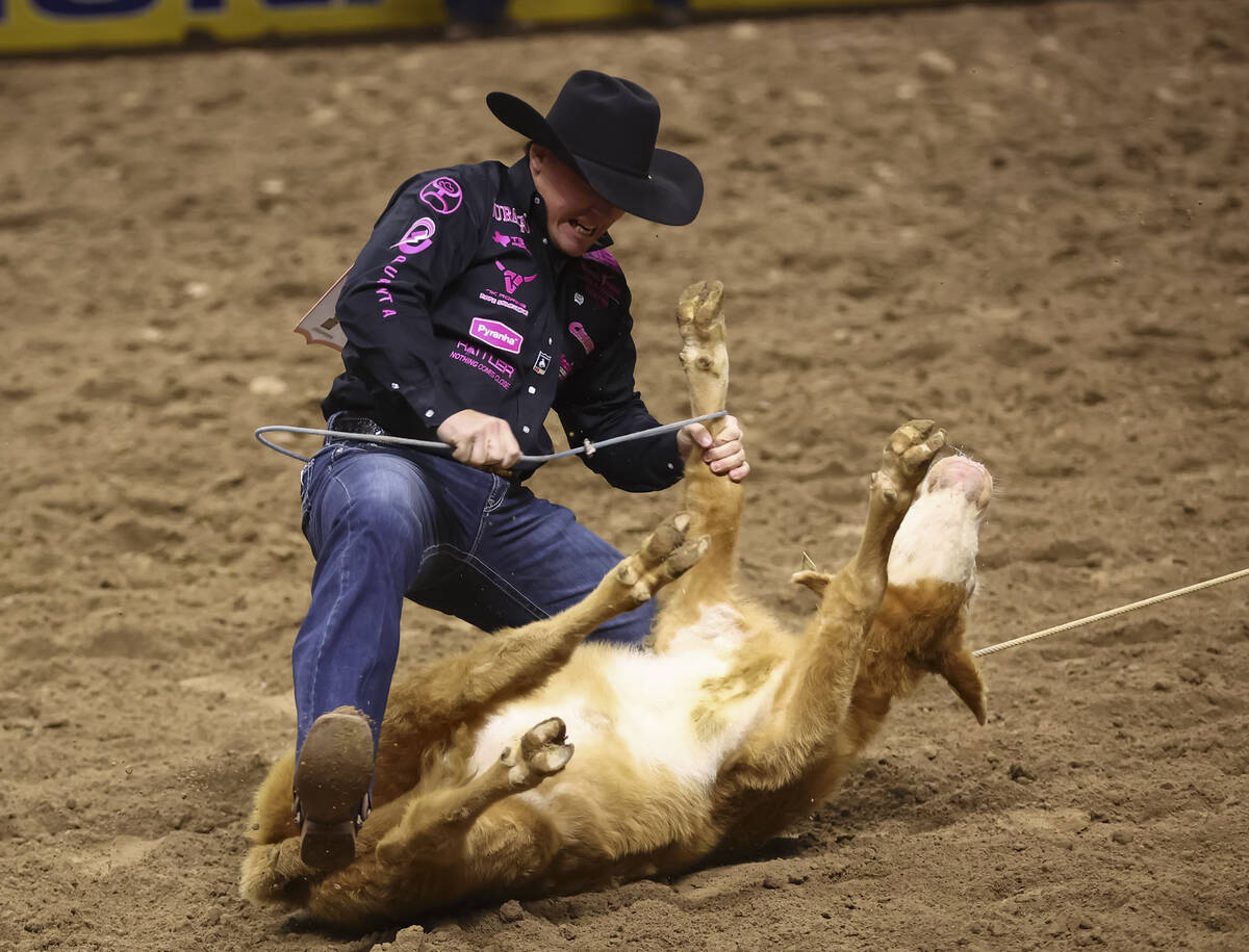 Riley Webb competes in tie-down roping during the fifth go-round of the National Finals Rodeo a ...