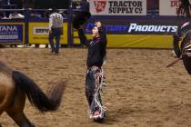 Damian Brennan reacts after placing first in saddle bronc riding during the fifth go-round of t ...