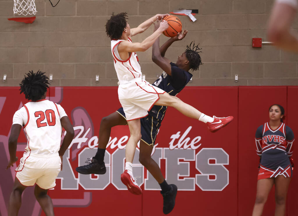 Spring Valley forward Nasir Greene (23) gets fouled by Arbor View forward Gunnar Robinson (5) d ...