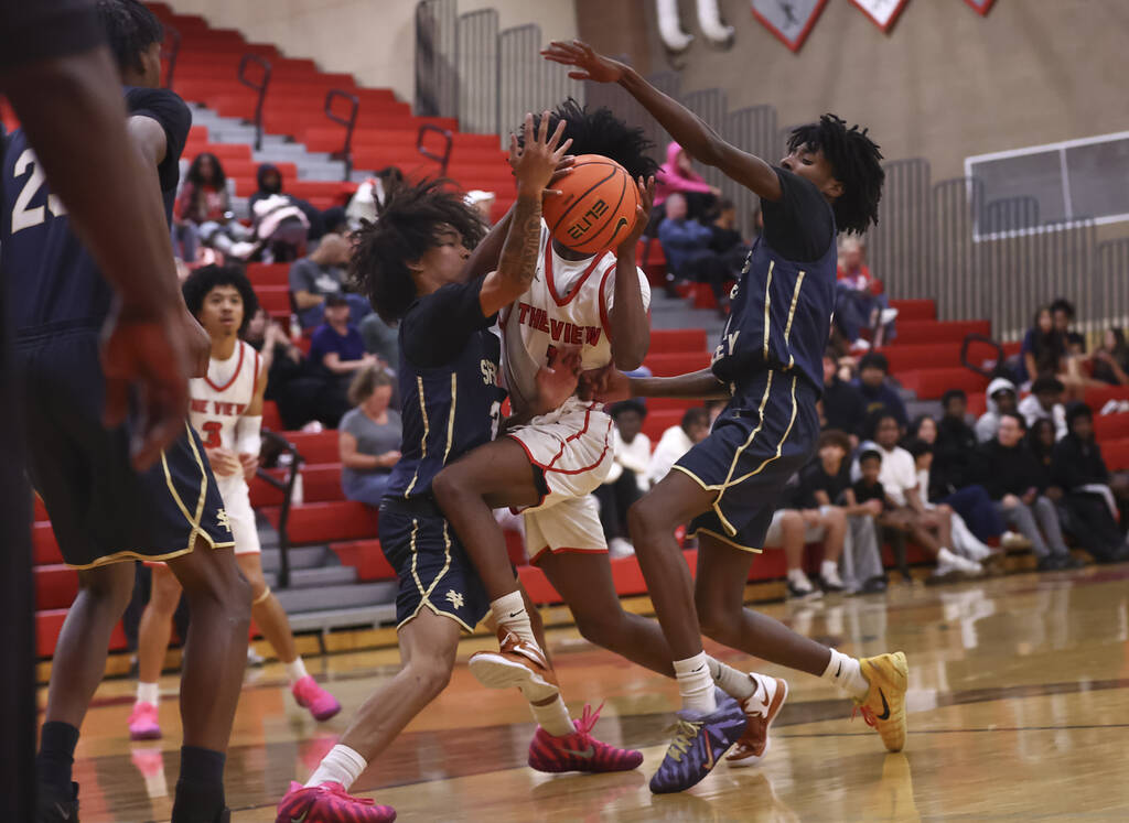 Arbor View guard Elijah Pierce (1) gets fouled by Spring Valley guard James Carson (3) during t ...