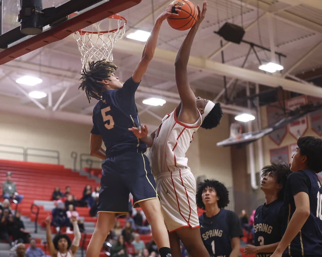 Spring Valley guard Azea Melo-Powell (5) blocks the shot of Arbor View center Dominic Givens (2 ...