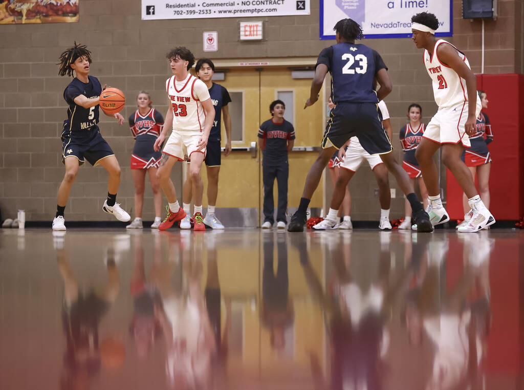 Spring Valley guard Azea Melo-Powell (5) passed the ball in front of Arbor View guard Thaddeus ...