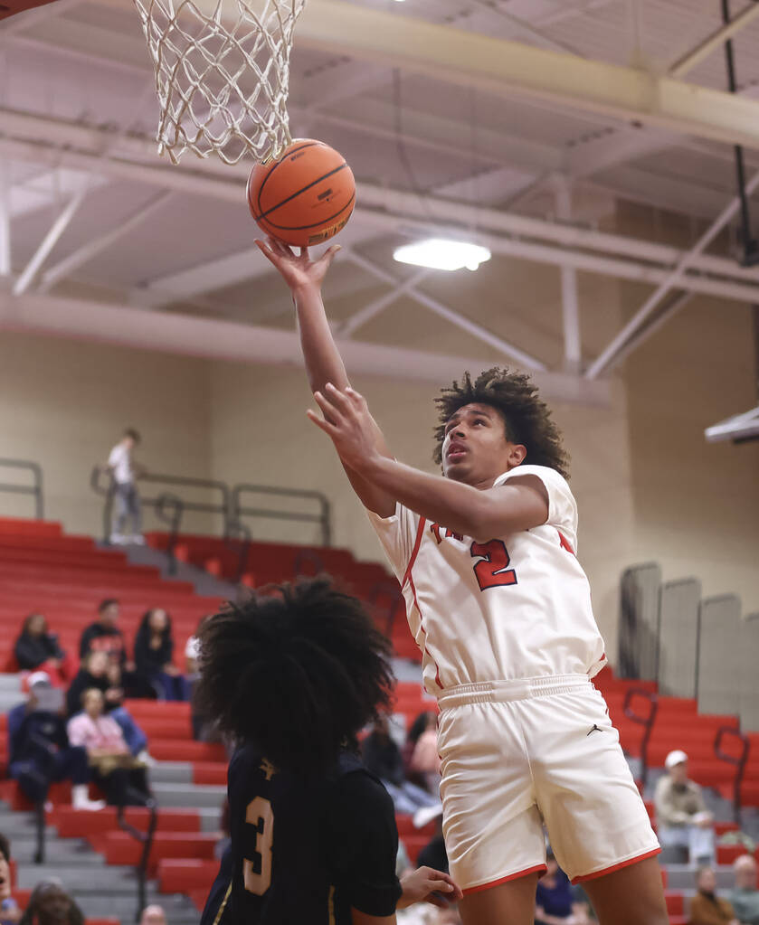 Arbor View forward Landon Woods (2) lays up the ball against Spring Valley guard James Carson ( ...