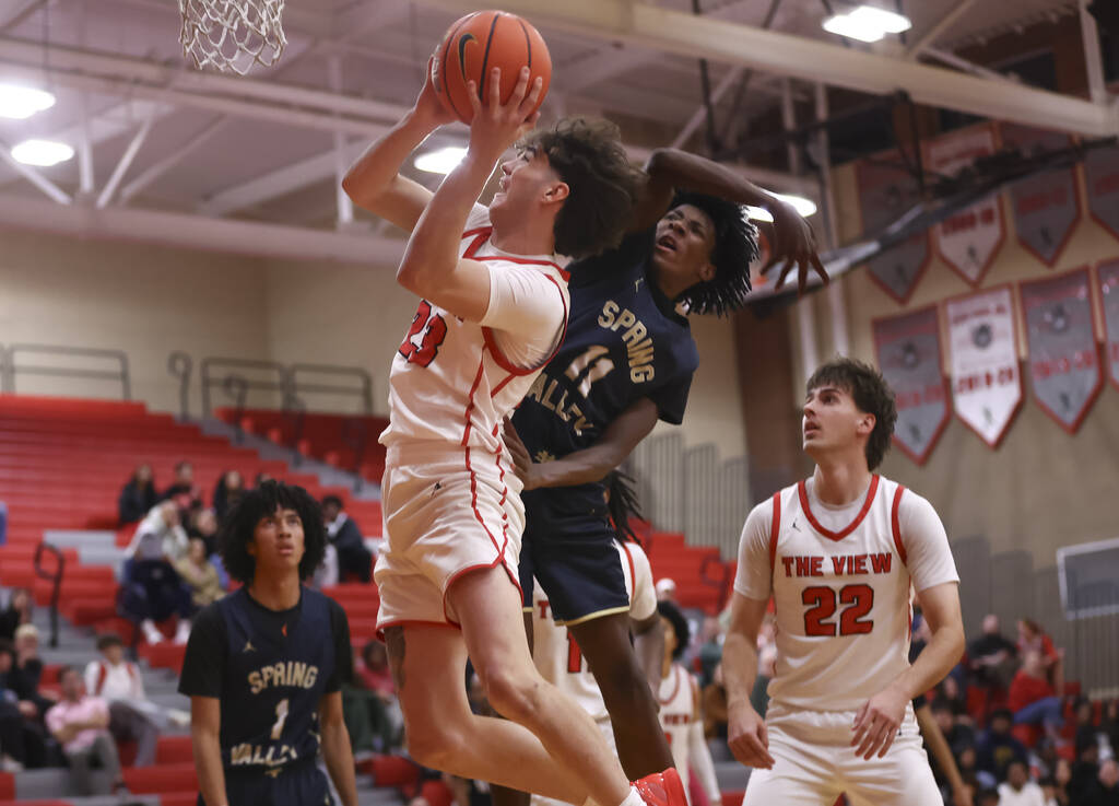 Arbor View guard Thaddeus Thatcher (23) lays up the ball under pressure from Spring Valley guar ...