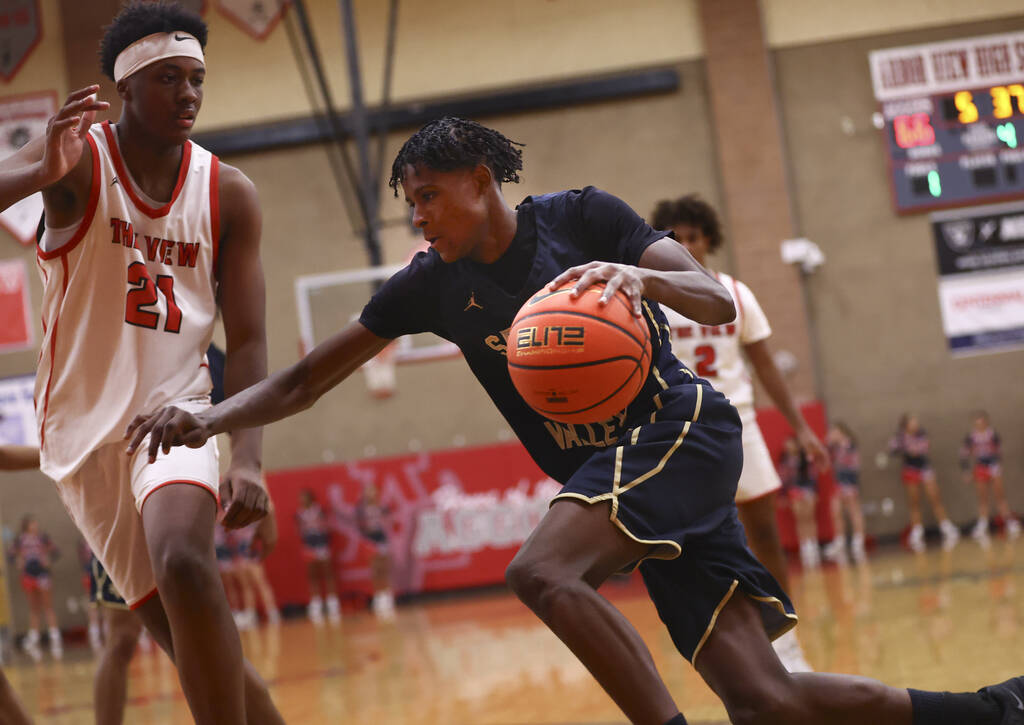 Spring Valley forward Nasir Greene (23) drives to the basket against Arbor View center Dominic ...