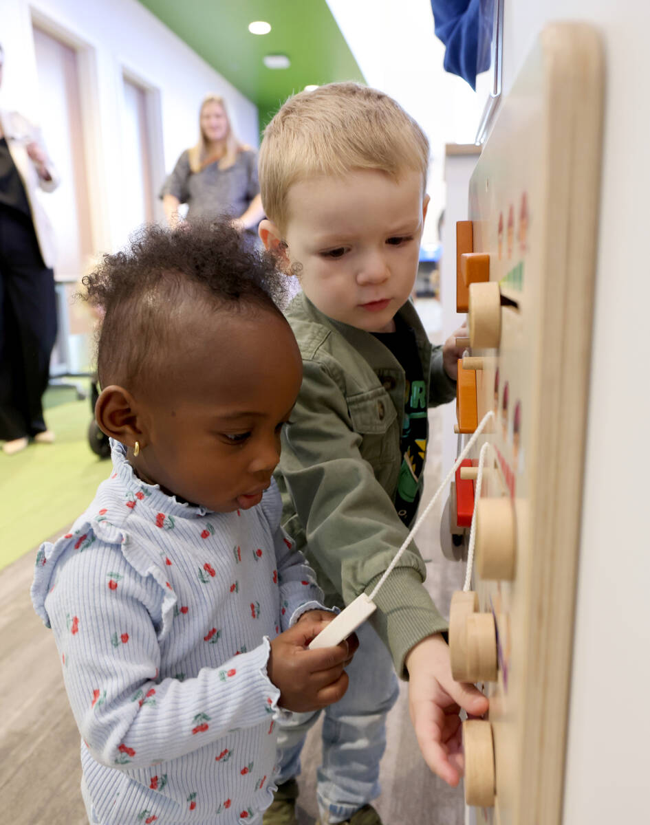 Mei Lin Clarke, 16 months, left, and Chase Watts, 2, play during the grand opening of the new W ...
