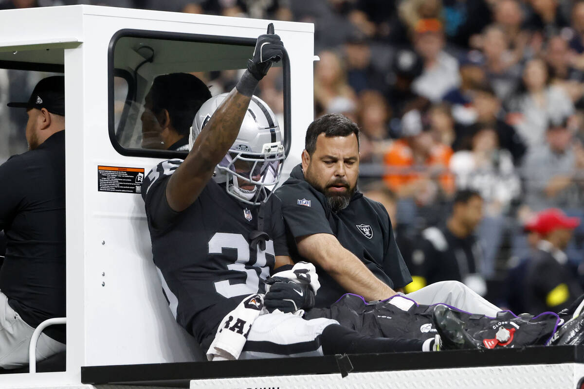 Raiders cornerback Kyu Blu Kelly (36) flashes a thumps-up as he is carted off the field after b ...