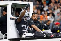 Raiders cornerback Kyu Blu Kelly (36) flashes a thumps-up as he is carted off the field after b ...