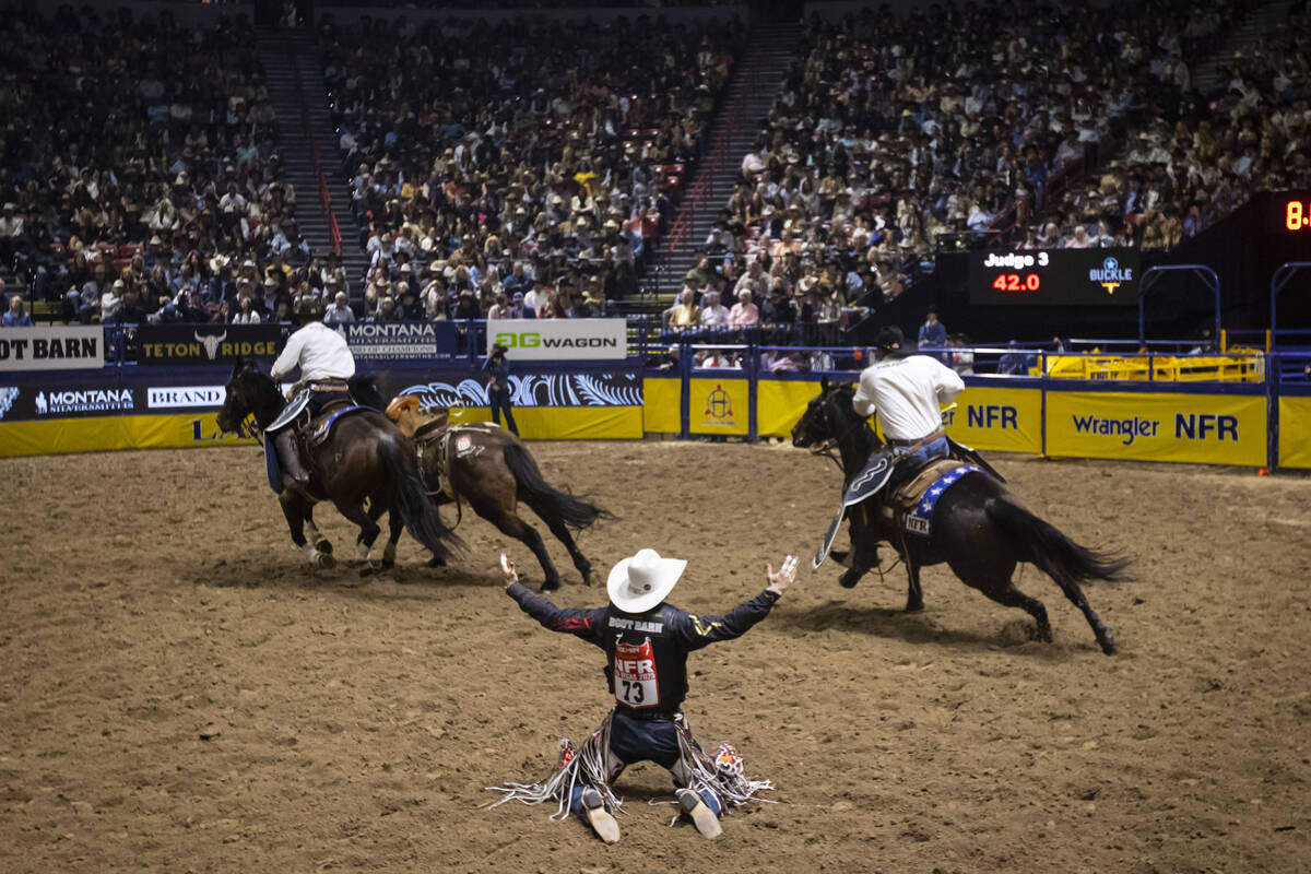 Lefty Holman reacts after competing in saddle bronc riding during the eighth go-round of the Na ...